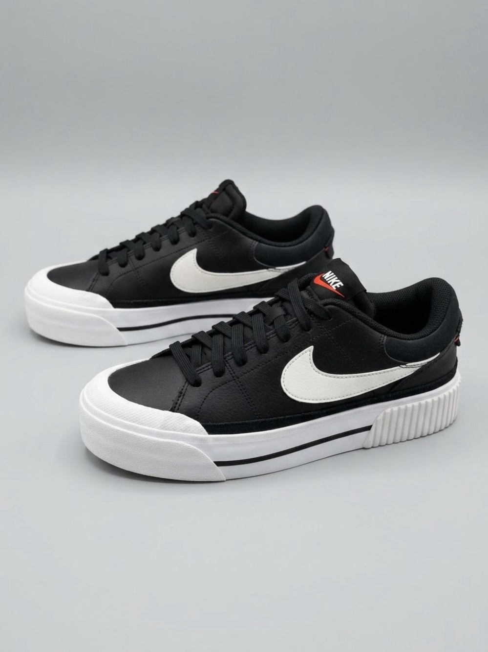Nike Black Sneakers with White Swoosh and Sole